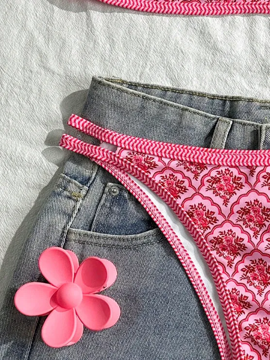 Printed pink split bikini set with exposed back and adjustable shoulder straps on woman