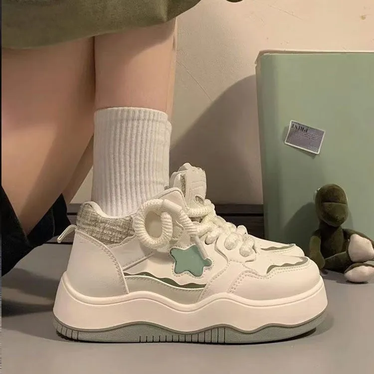 Women's green patent leather platform sneakers with round toe and lace-up closure on rubber sole