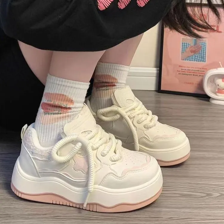 Women's green patent leather platform sneakers with round toe and lace-up closure on rubber sole