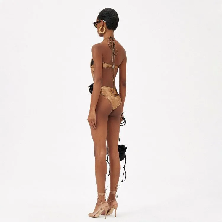 Gold coloured halter neck one piece swimsuit with a handmade hollow out flower design on the front.