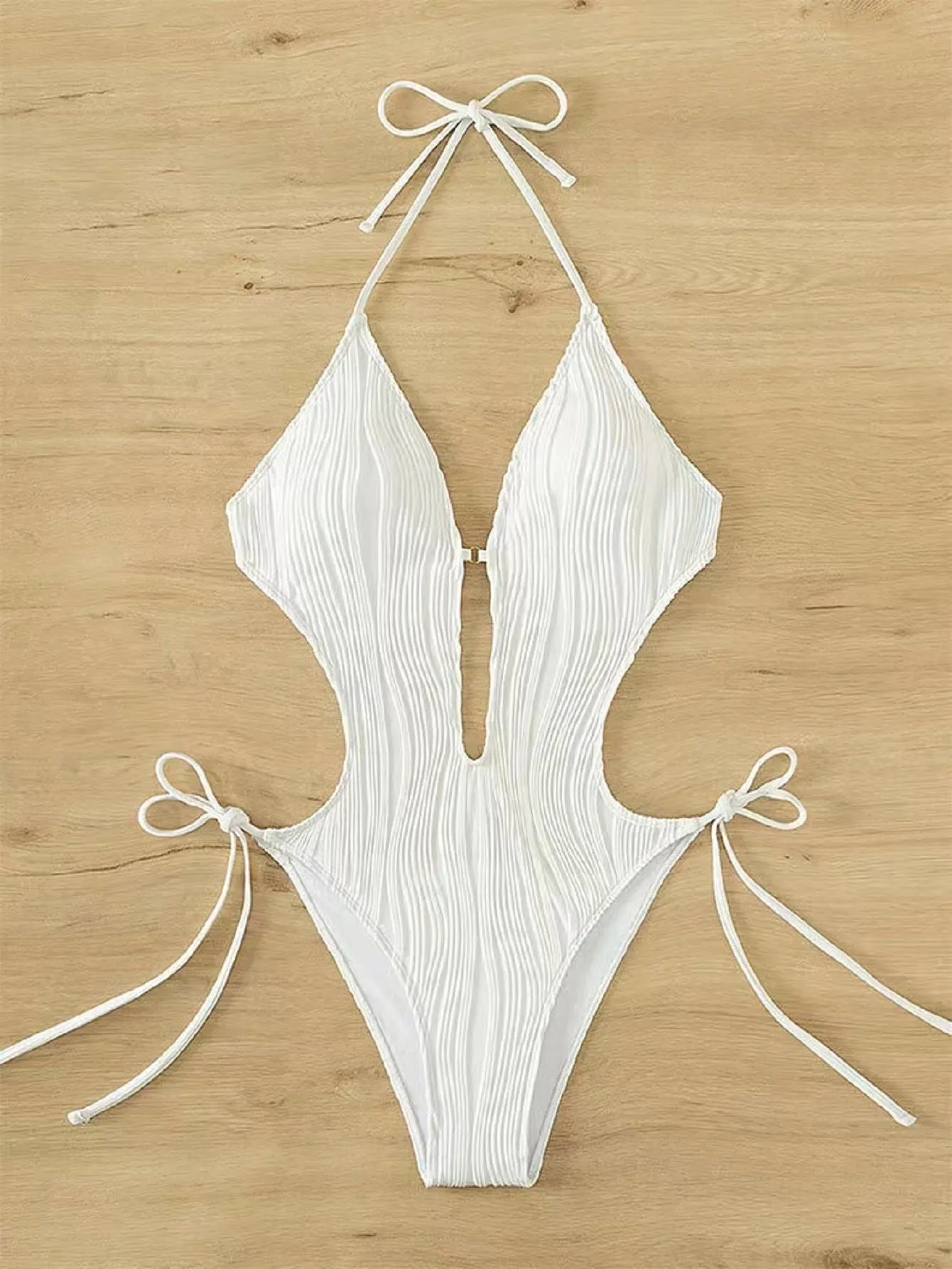 Women's black lace-up triangle bikini swimsuit on mannequin showing adjustable top details