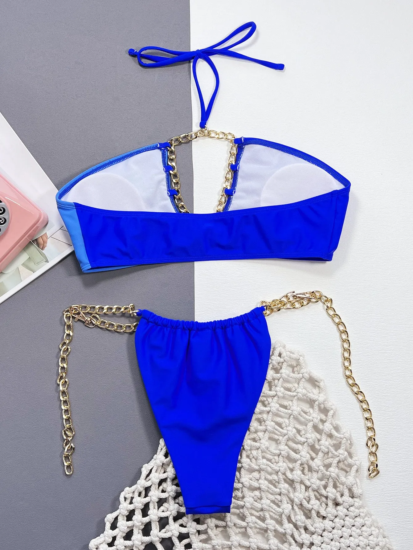 Solid blue women's split bikini swimsuit on a white background