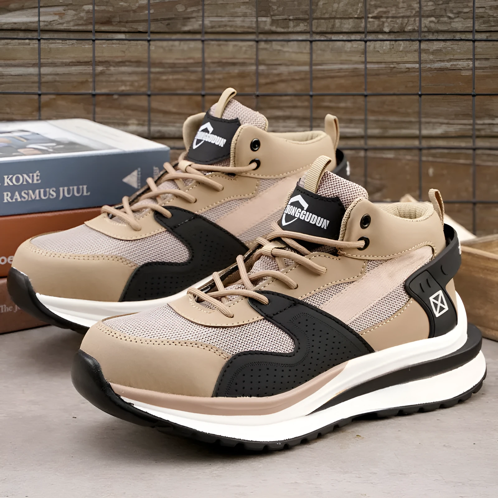 Low-top black safety work boot with lace-up front and steel toe cap on a construction site background.