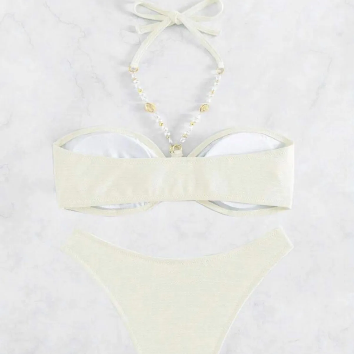 Women's solid colour halter bikini set in creamy-white, shown front-on.