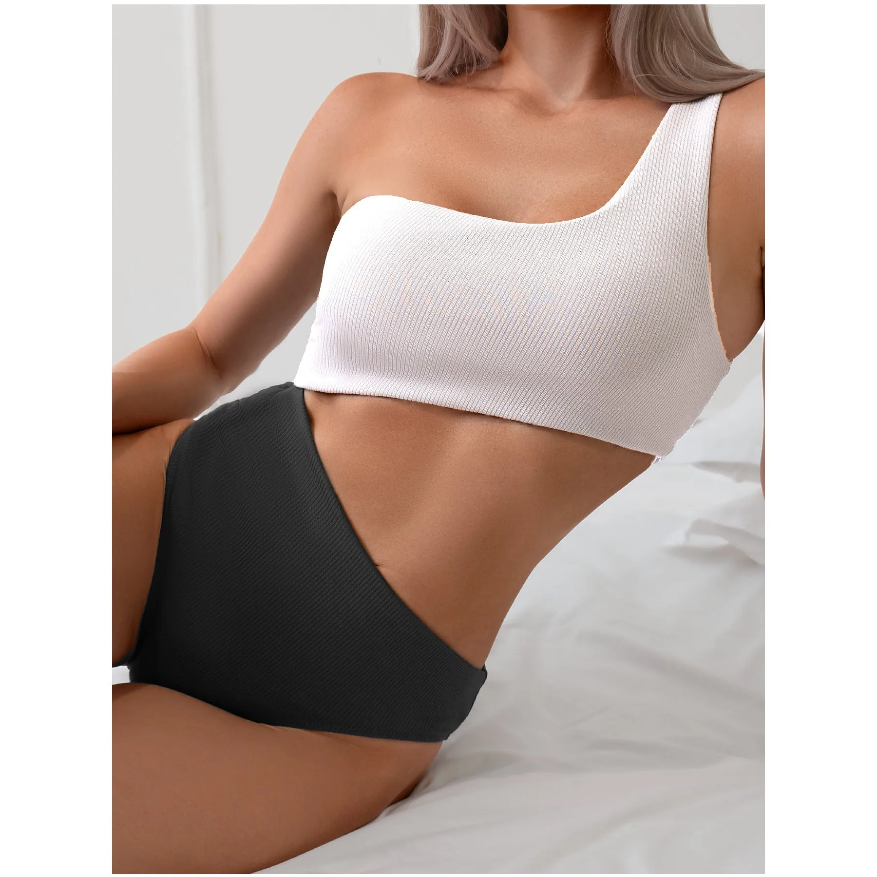 Light gray one-shoulder one-piece swimsuit on a white background.