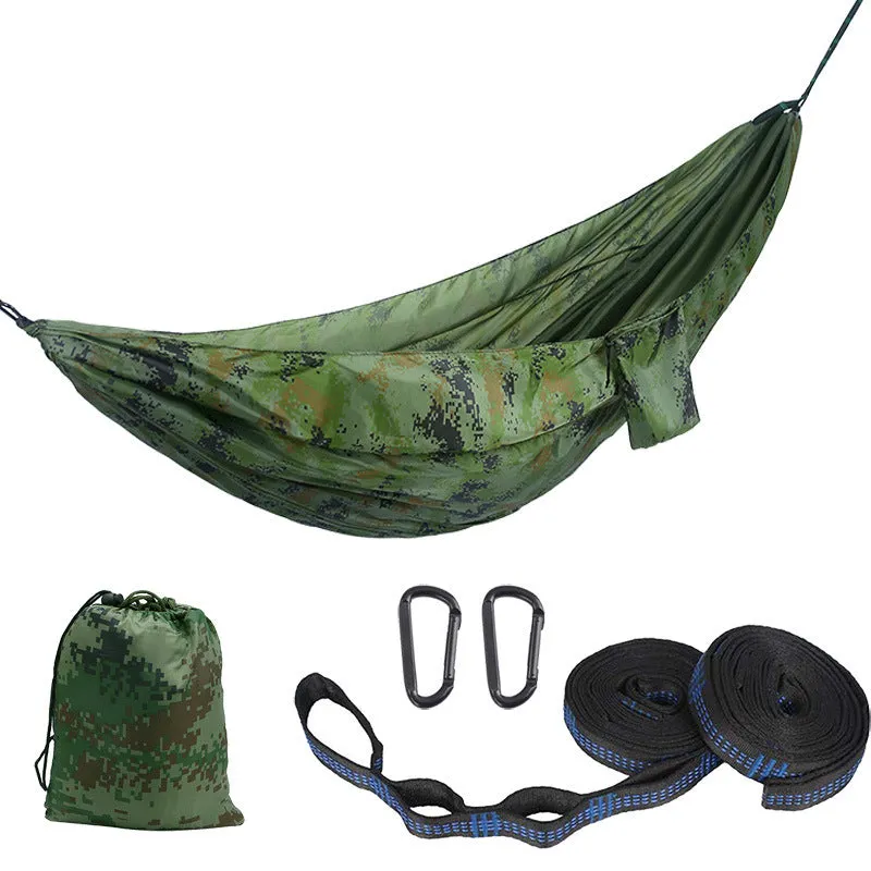 Parachute cloth camping hammock in 210T nylon hanging between trees with included ropes and buckles