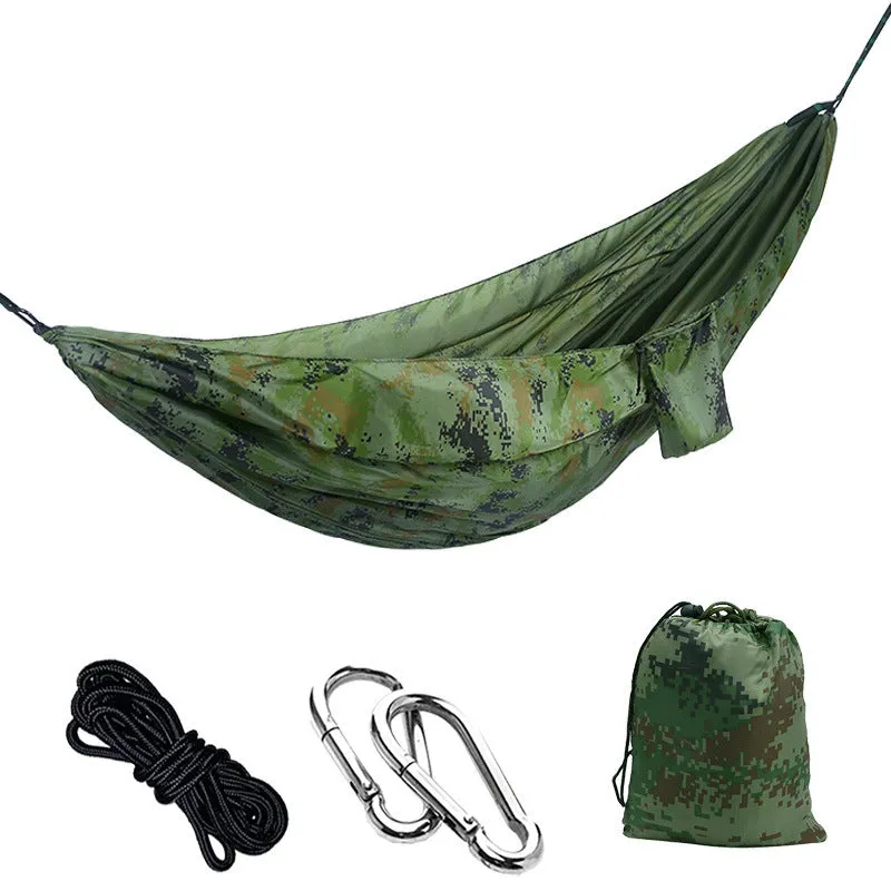 Parachute cloth camping hammock in 210T nylon hanging between trees with included ropes and buckles