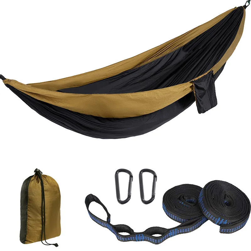 Parachute cloth camping hammock in 210T nylon hanging between trees with included ropes and buckles