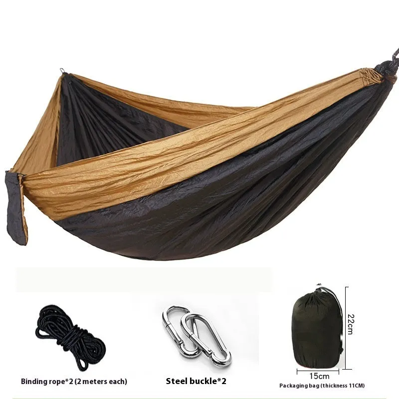 Parachute cloth camping hammock in 210T nylon hanging between trees with included ropes and buckles