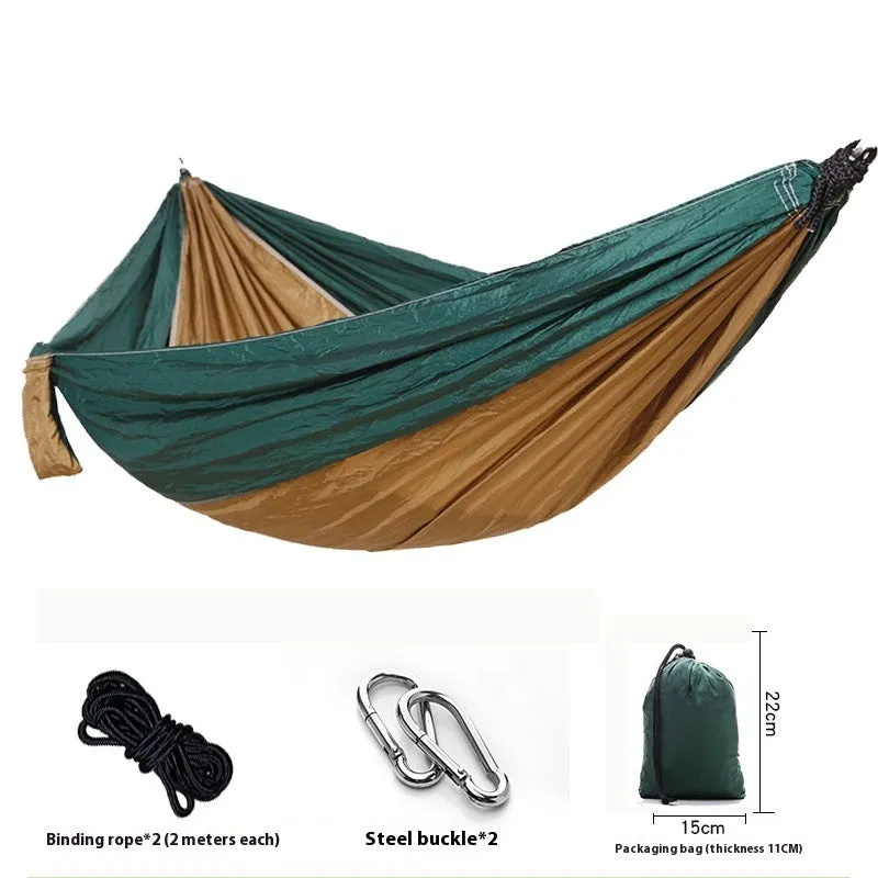 Parachute cloth camping hammock in 210T nylon hanging between trees with included ropes and buckles