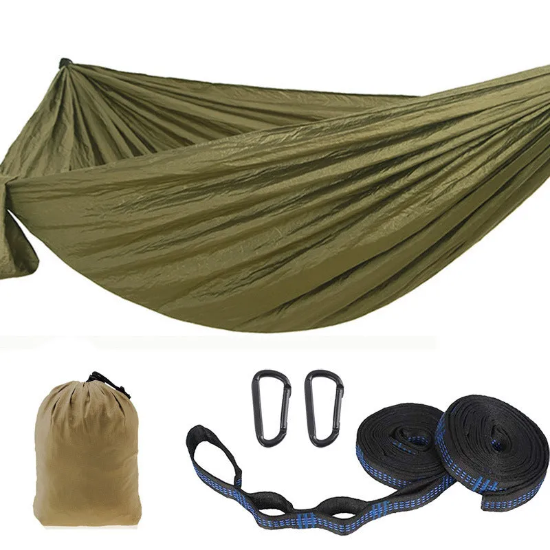 Parachute cloth camping hammock in 210T nylon hanging between trees with included ropes and buckles