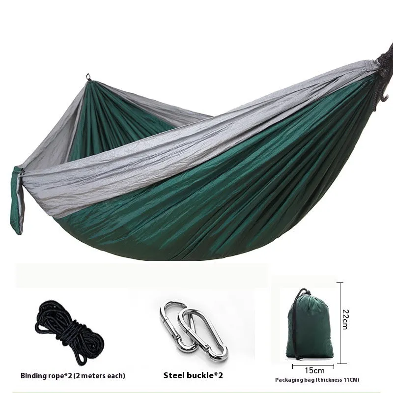 Parachute cloth camping hammock in 210T nylon hanging between trees with included ropes and buckles