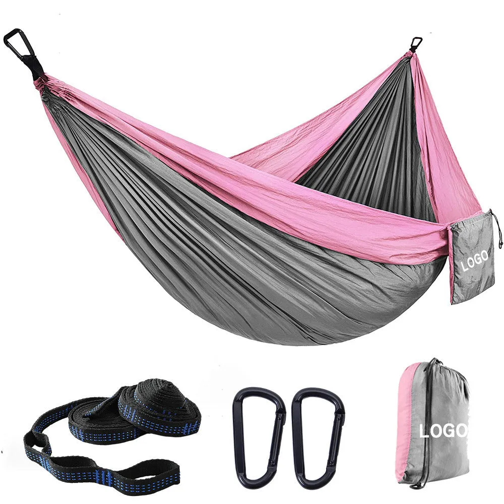 Parachute cloth camping hammock in 210T nylon hanging between trees with included ropes and buckles