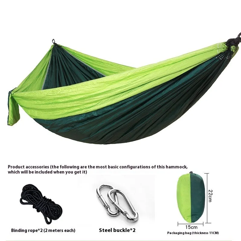 Parachute cloth camping hammock in 210T nylon hanging between trees with included ropes and buckles
