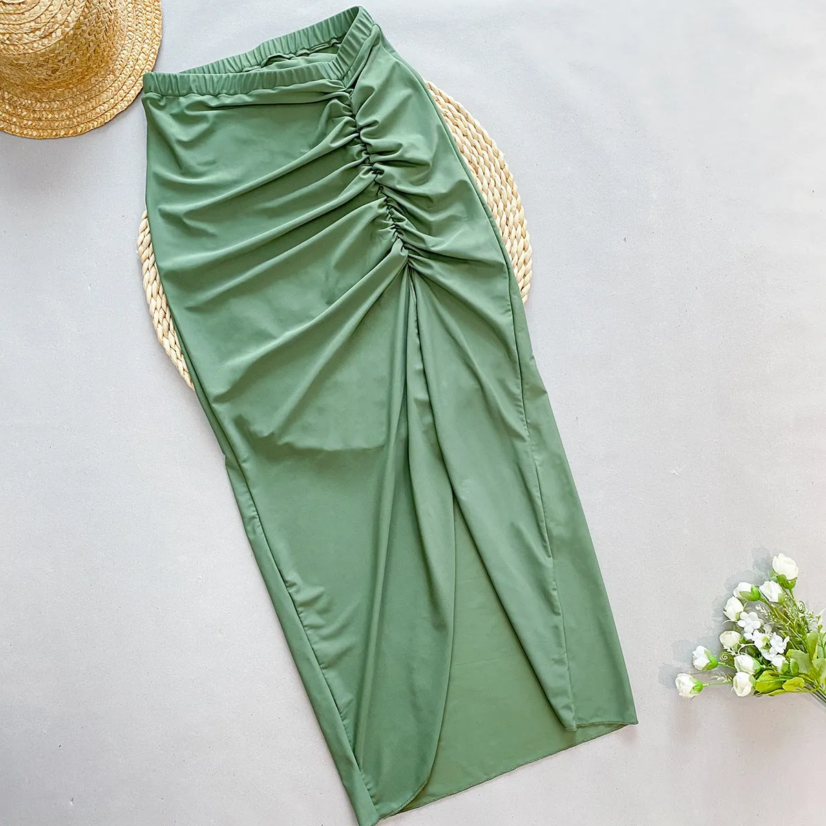 Women's brown one-piece swimsuit with a matching detachable beige skirt laid flat.