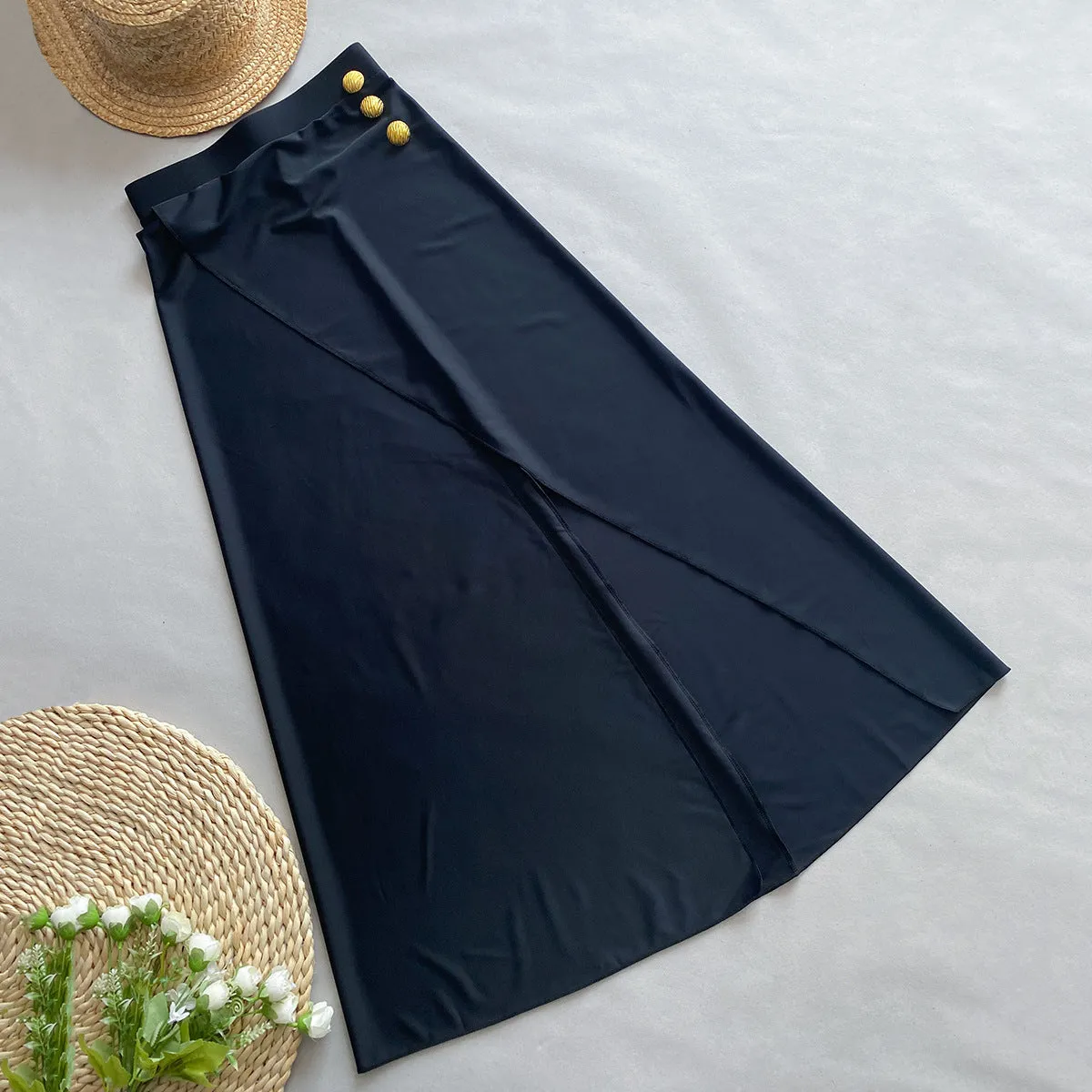Women's brown one-piece swimsuit with a matching detachable beige skirt laid flat.