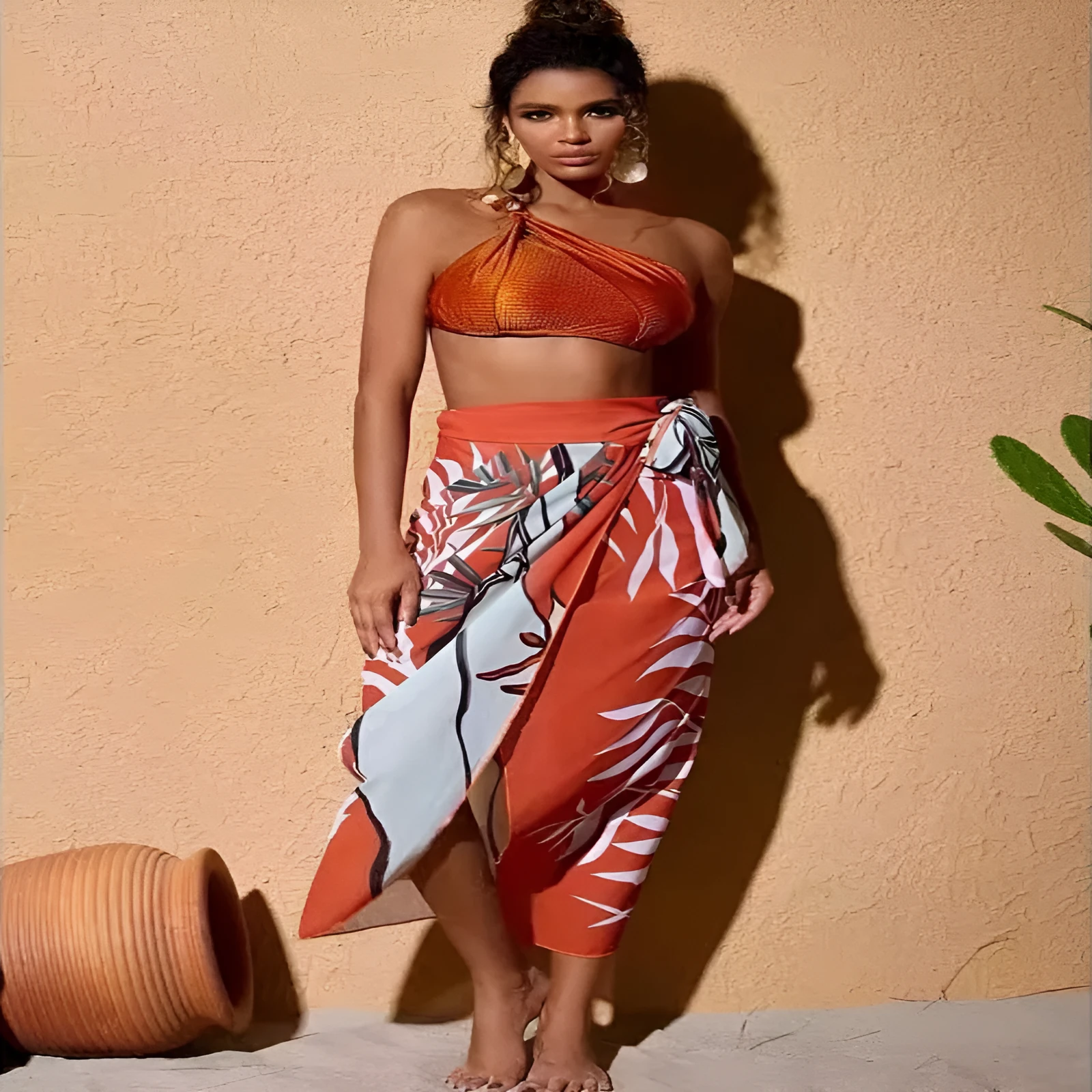 Women's brown push up high waist swimsuit with a split brief design and a sheer black chiffon dress overlay.