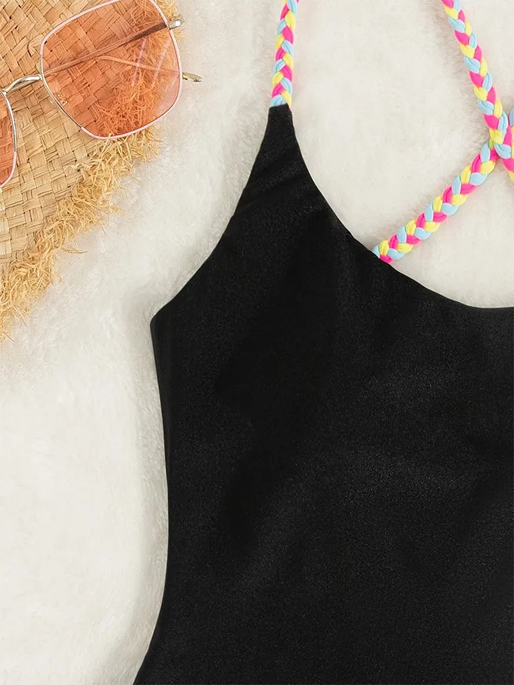 Black solid colour one-piece swimsuit with backless and sleeveless design.