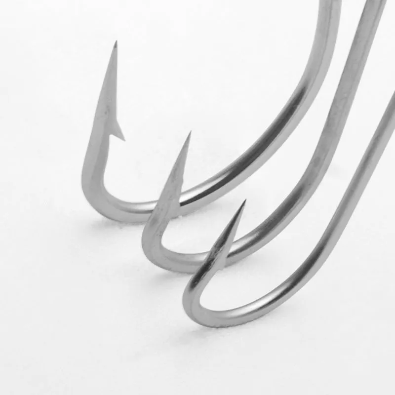 Assortment of alloy sea fishing hooks on a blue background for ocean boat fishing.
