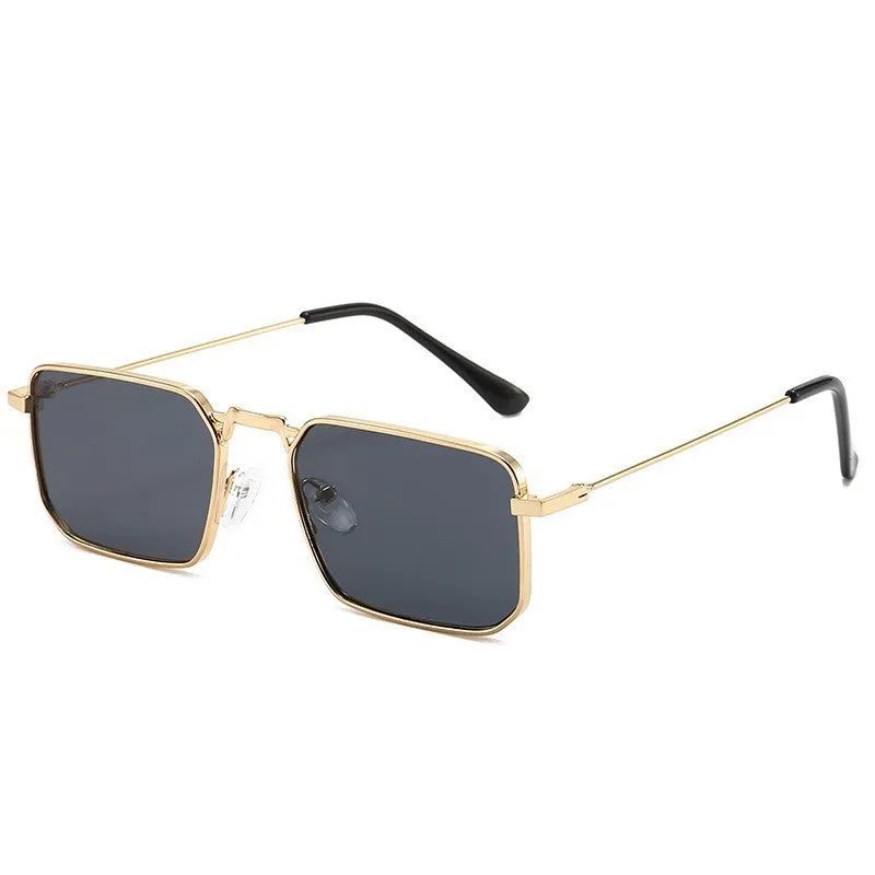 Square-shaped steampunk sunglasses for men with gold frame and grey lenses on a plain background