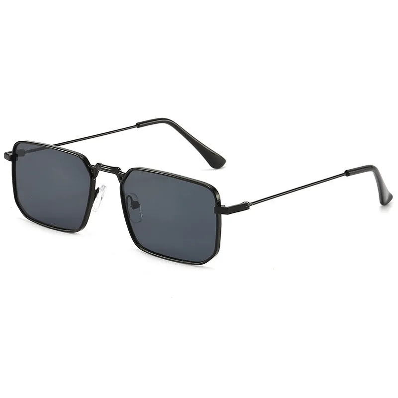 Square-shaped steampunk sunglasses for men with gold frame and grey lenses on a plain background