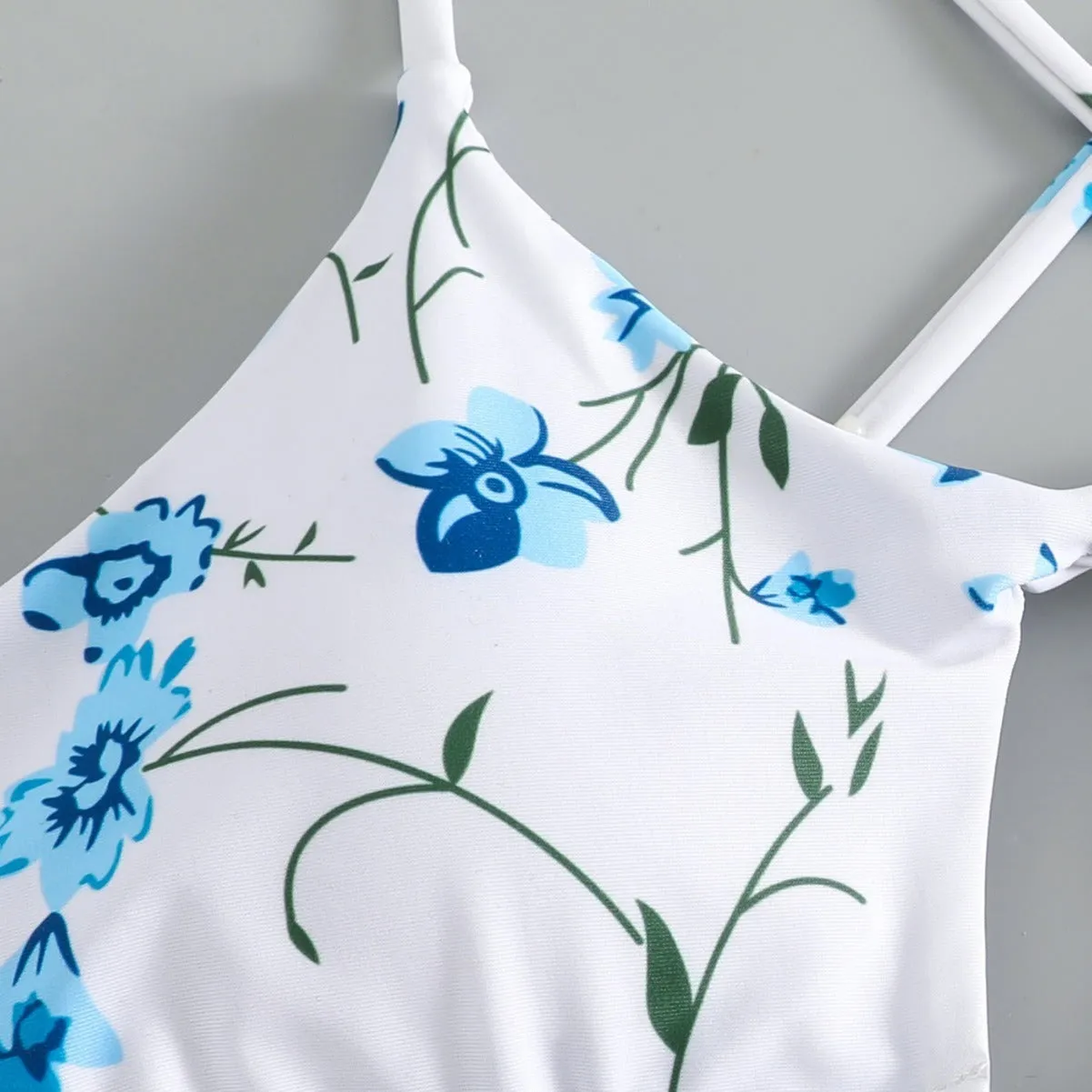 Women's floral swimsuit set with tie-neck triangle top and matching shorts