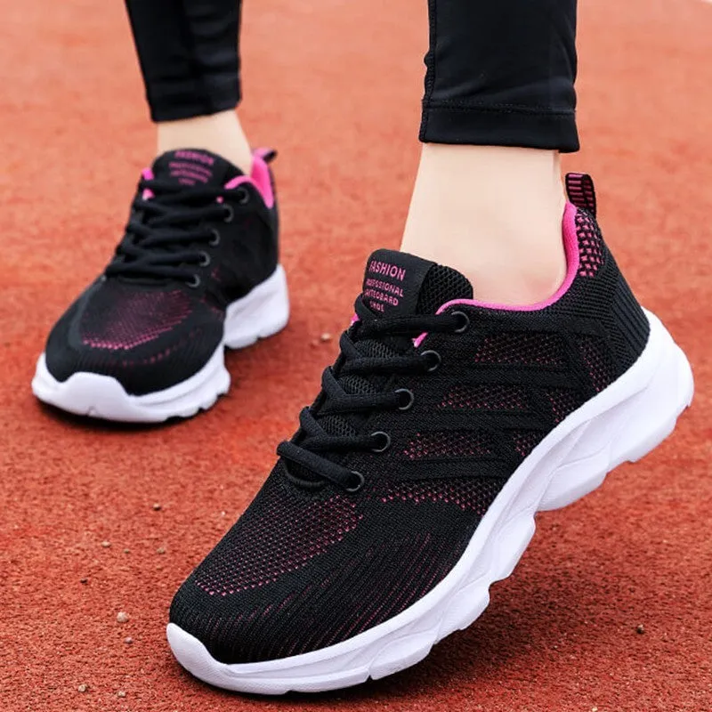 Women's white mesh leisure shoes with lace-up closure and low heel on neutral background