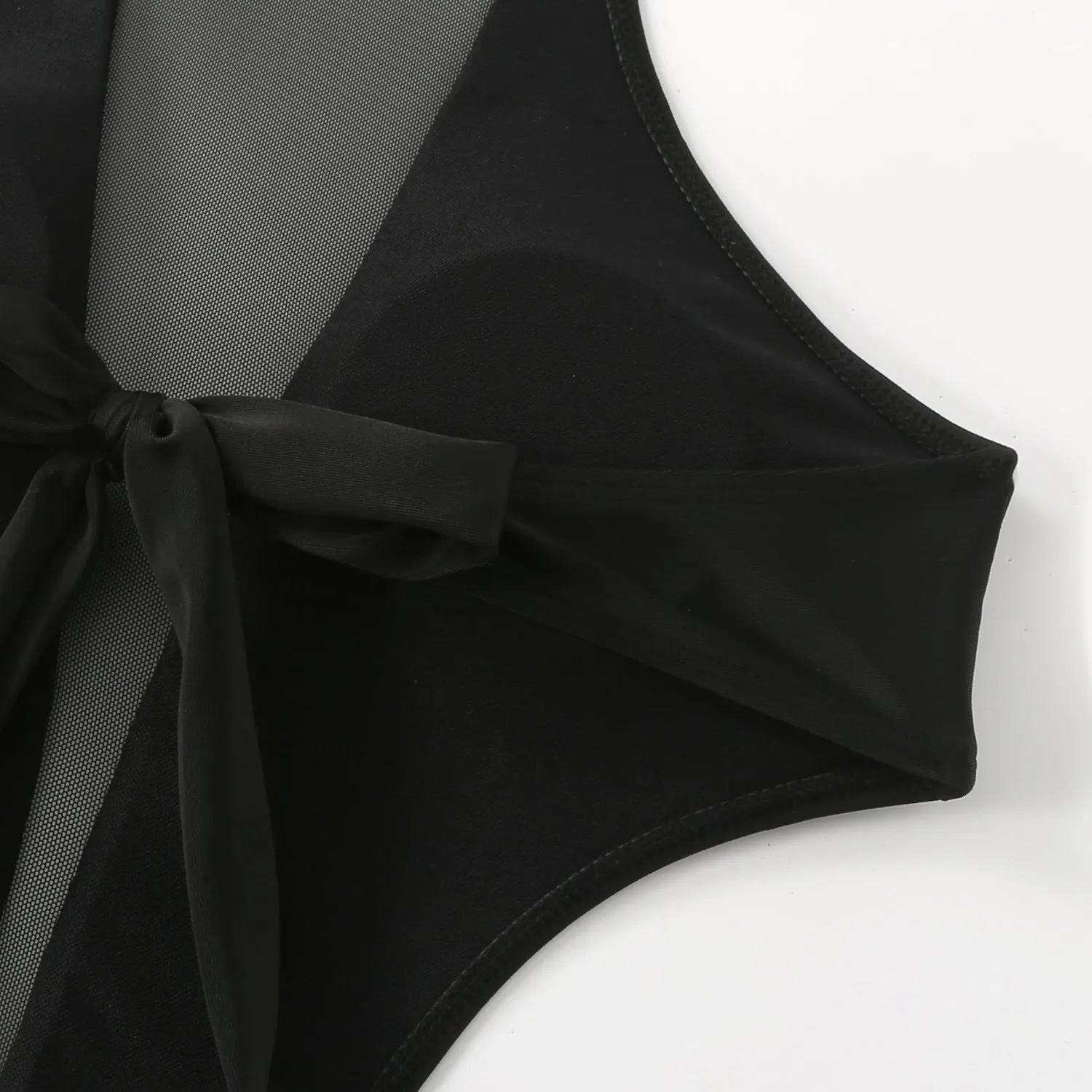Black one-piece swimsuit with nude back design and hollow-out detailing on female model