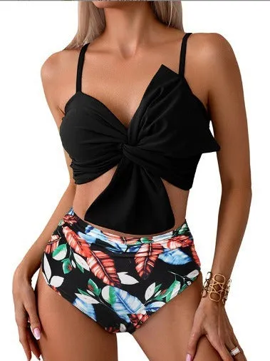 Women's orange nylon bikini set with large white bow print, showing top and swim trunks.