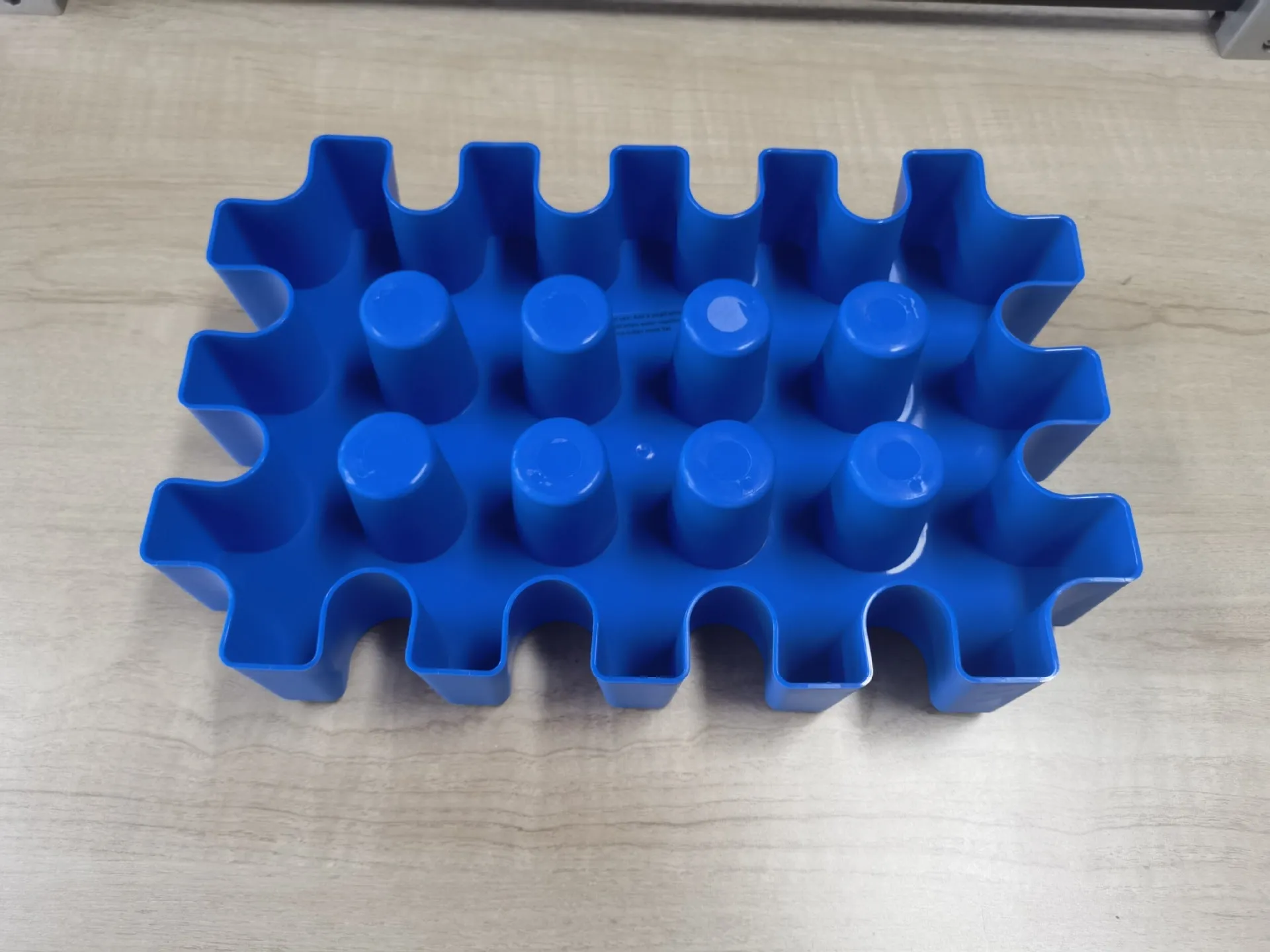 Blue plastic reusable ice block maker tray for outdoor coolers and camping.