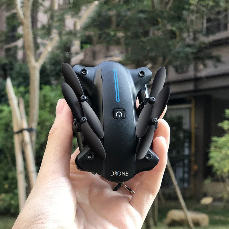 Mini folding drone with 4K camera in black, folded size 8x4x7cm, showing four rotors and remote controller