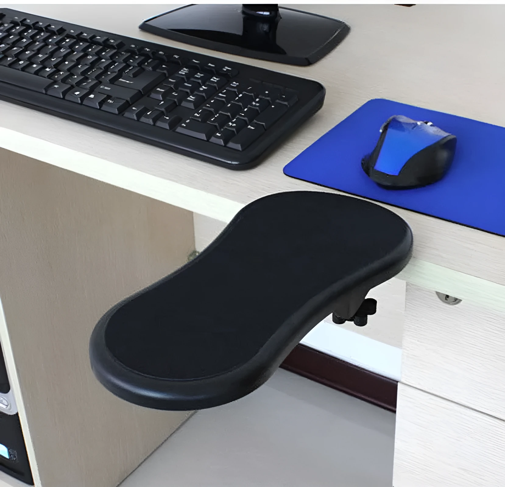 Black plastic rotating computer hand bracket wrist pad showing 180-degree adjustment on a desk.