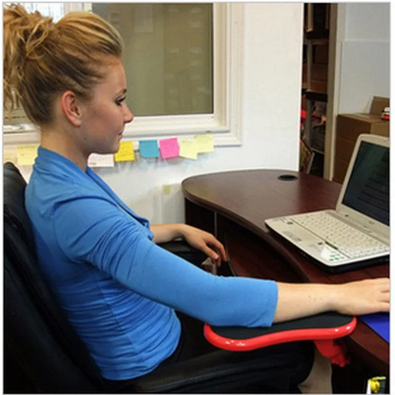 Black plastic rotating computer hand bracket wrist pad showing 180-degree adjustment on a desk.