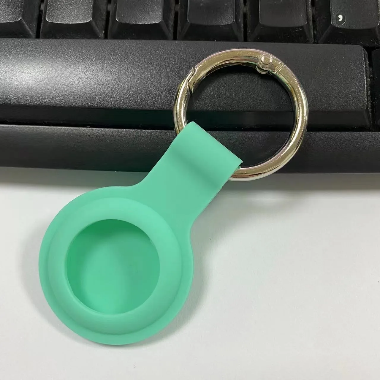Silicone AirTag protective case with metal snap button in multiple colour options