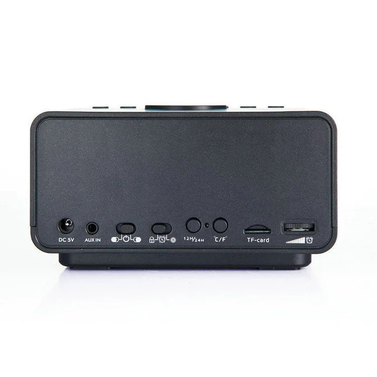 Black and white wireless alarm clock Bluetooth speaker with control buttons on top.