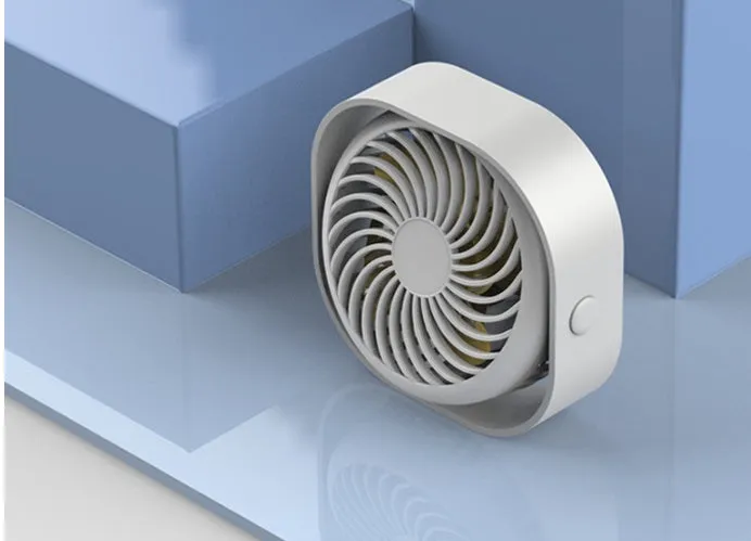 A small, modern USB desk fan in blue with a rotating head on a white desk.