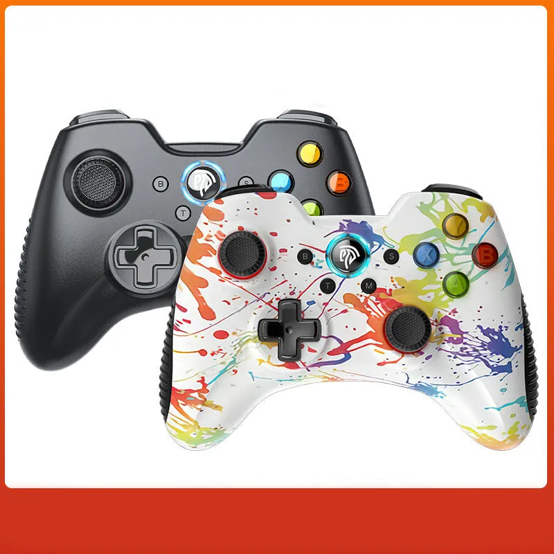 Black dual-mode wireless PC game controller with coloured buttons on a desk next to its storage bag and adapter.