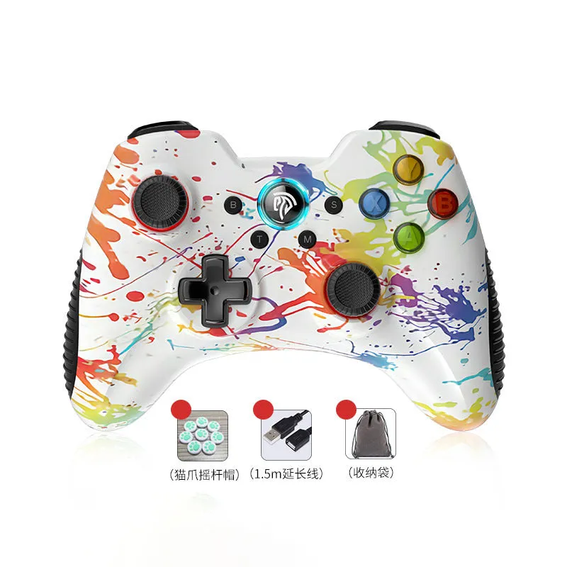 Black dual-mode wireless PC game controller with coloured buttons on a desk next to its storage bag and adapter.