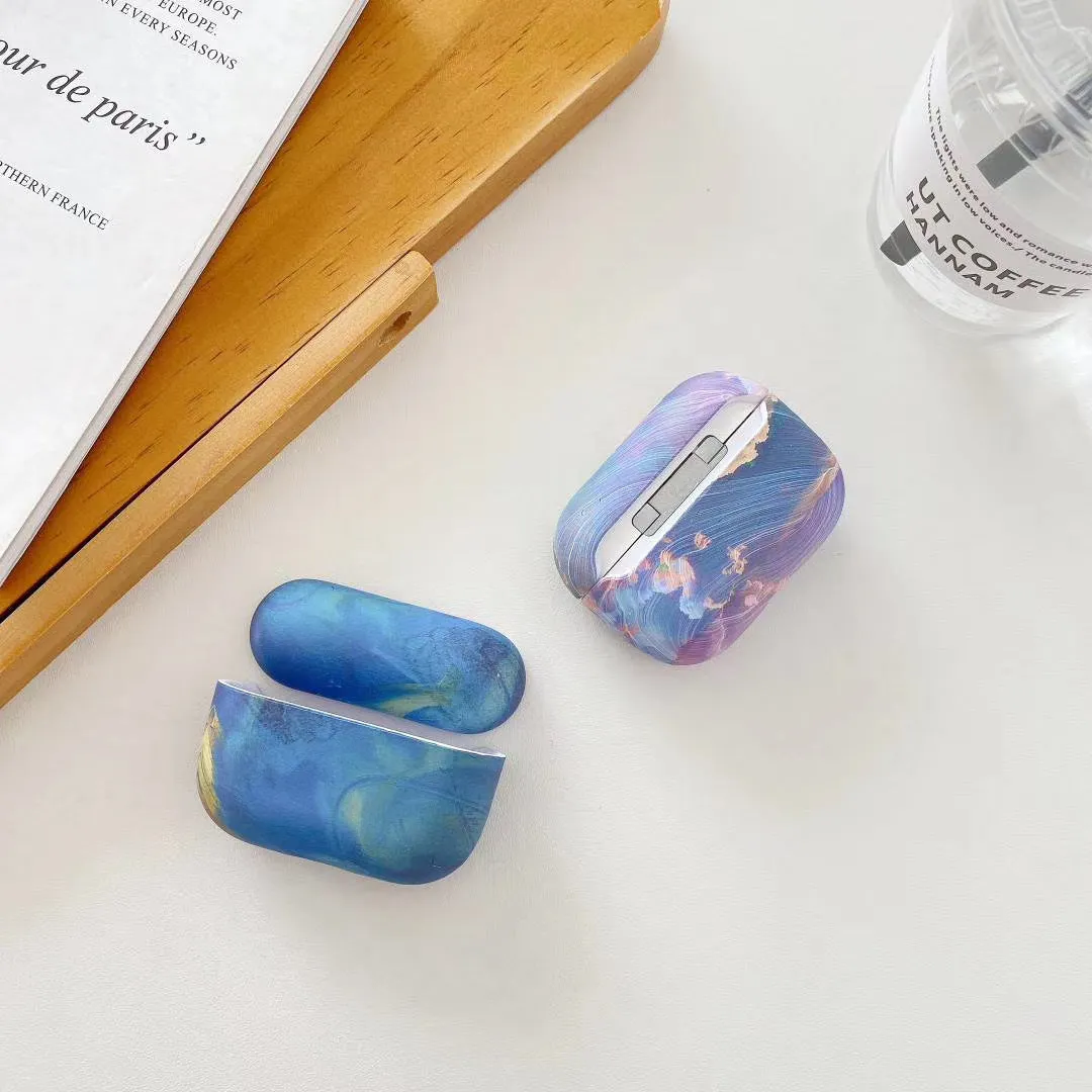 Hard plastic protective sleeve for Apple AirPods in pink and blue watercolour designs.