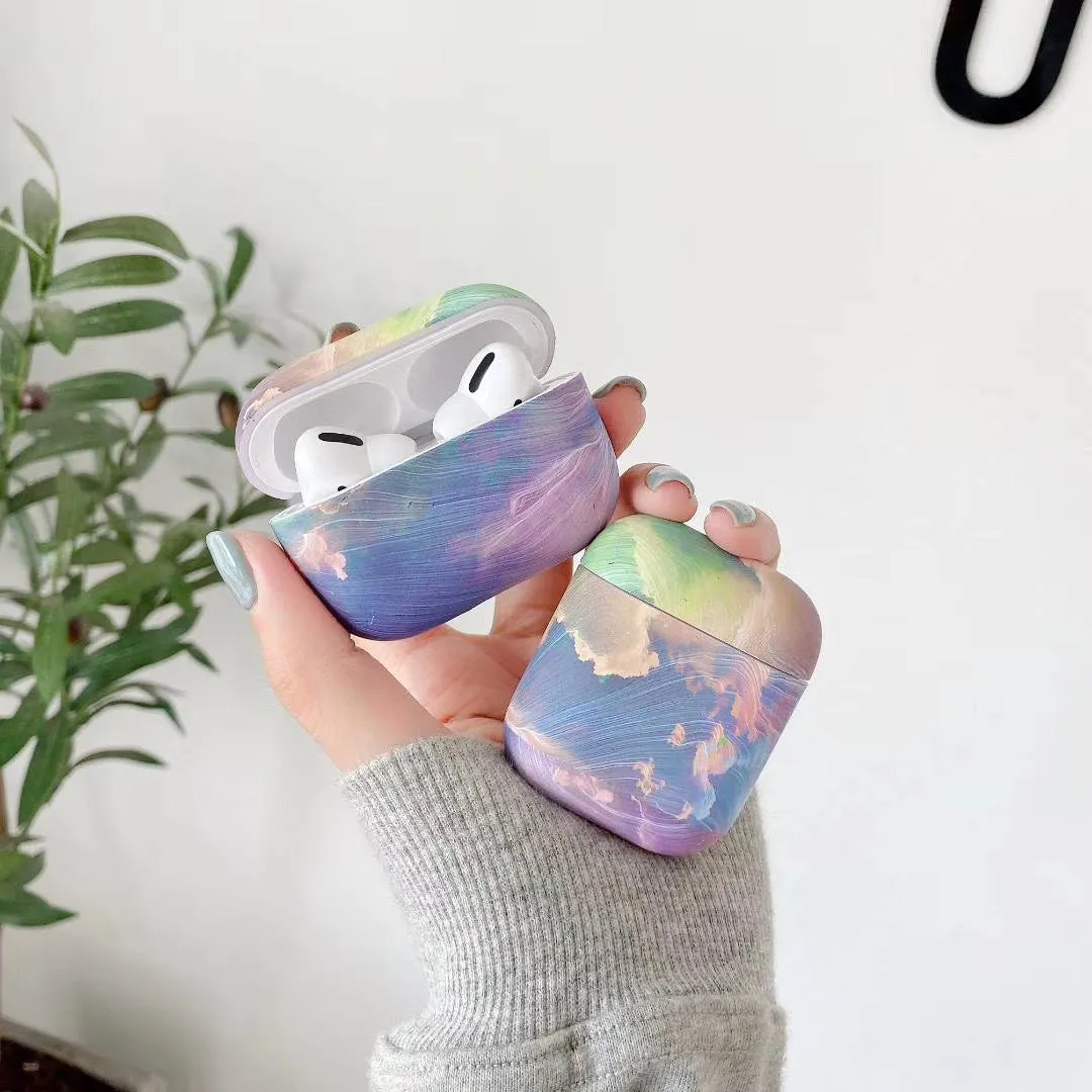 Hard plastic protective sleeve for Apple AirPods in pink and blue watercolour designs.