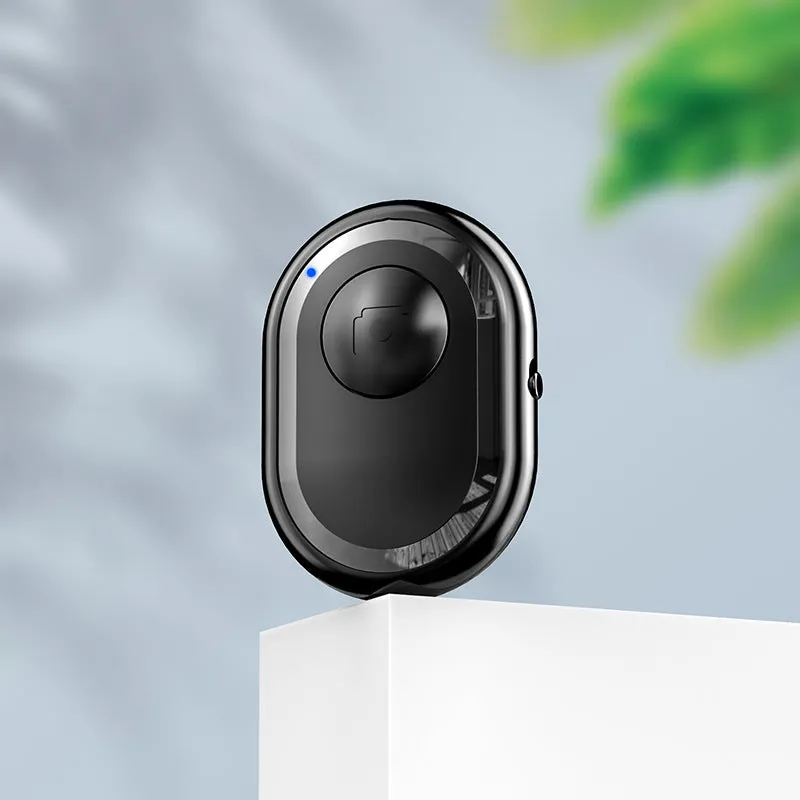 Wireless Bluetooth photo remote control in black, pink, or purple colours showing compact size