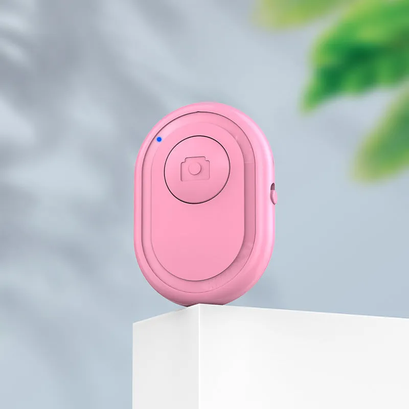 Wireless Bluetooth photo remote control in black, pink, or purple colours showing compact size