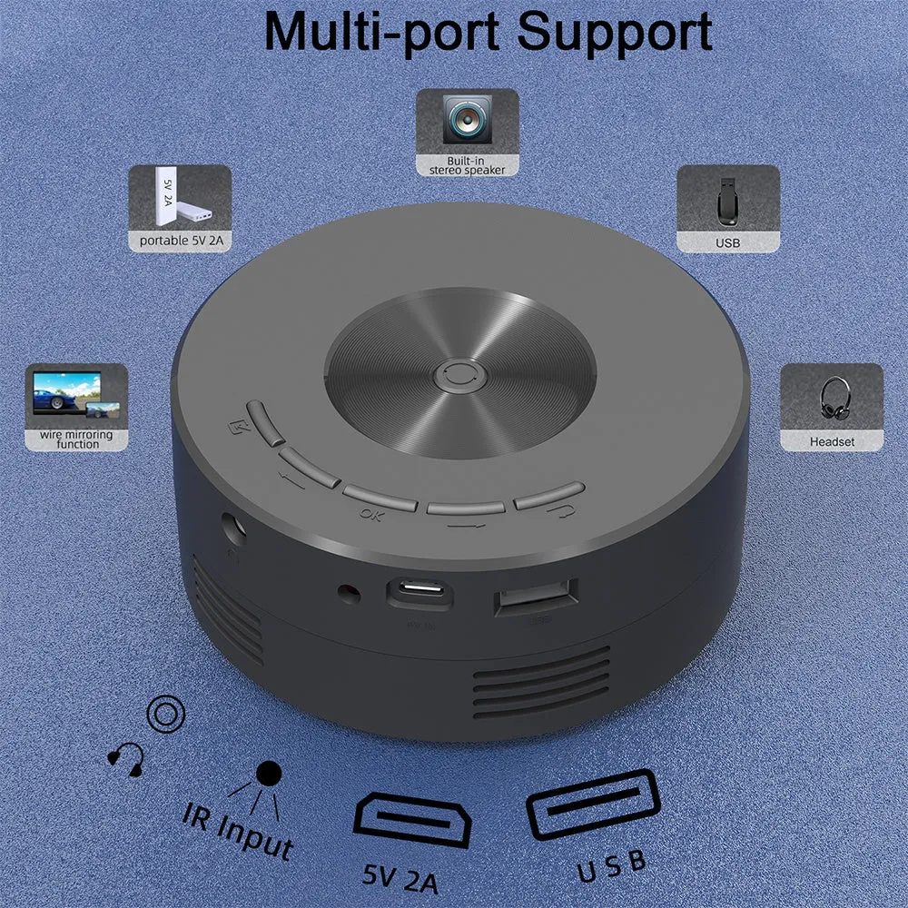 Black mini portable home projector for children next to a mobile phone.