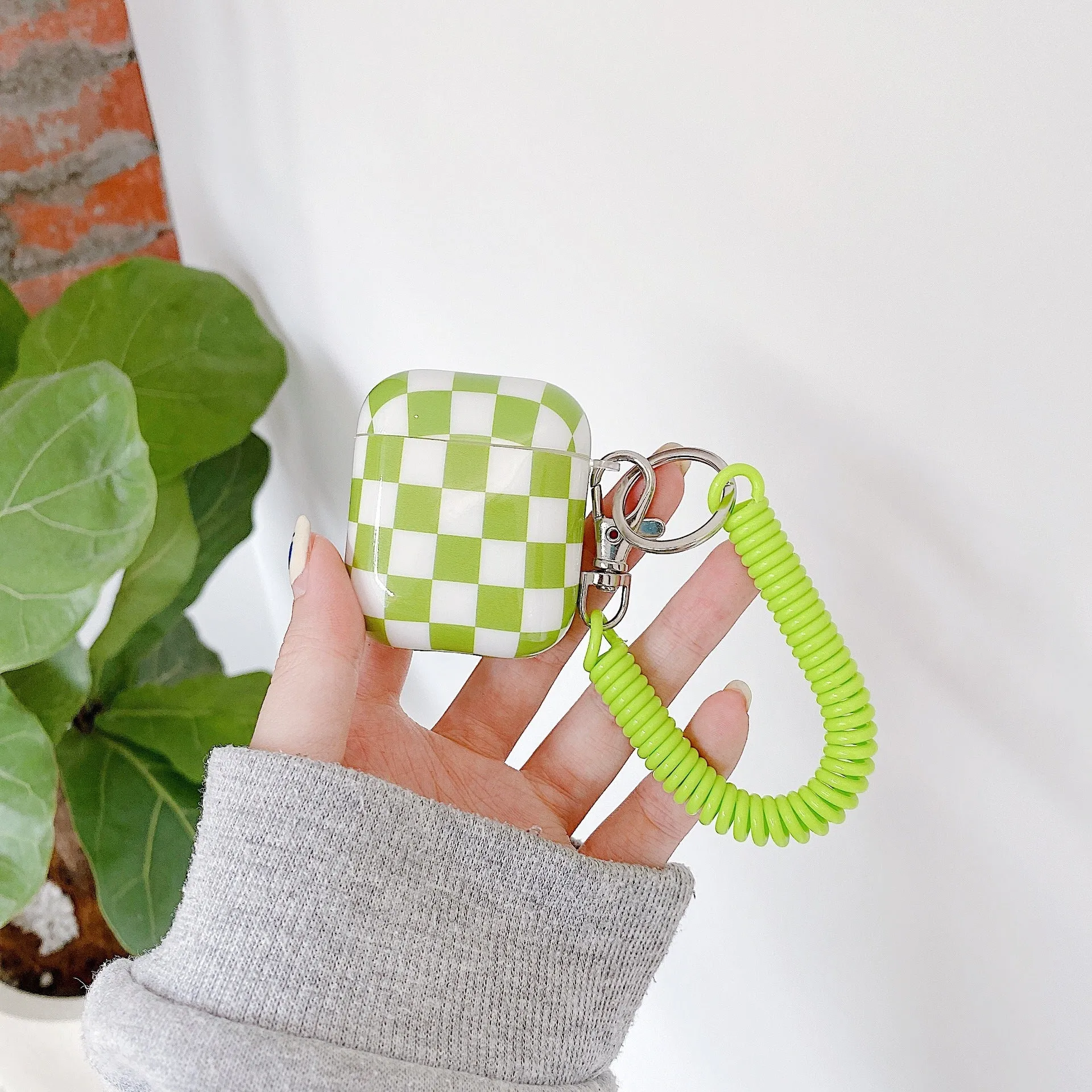 Black and green checkerboard pattern TPU case for Apple AirPods with optional pendant attachments