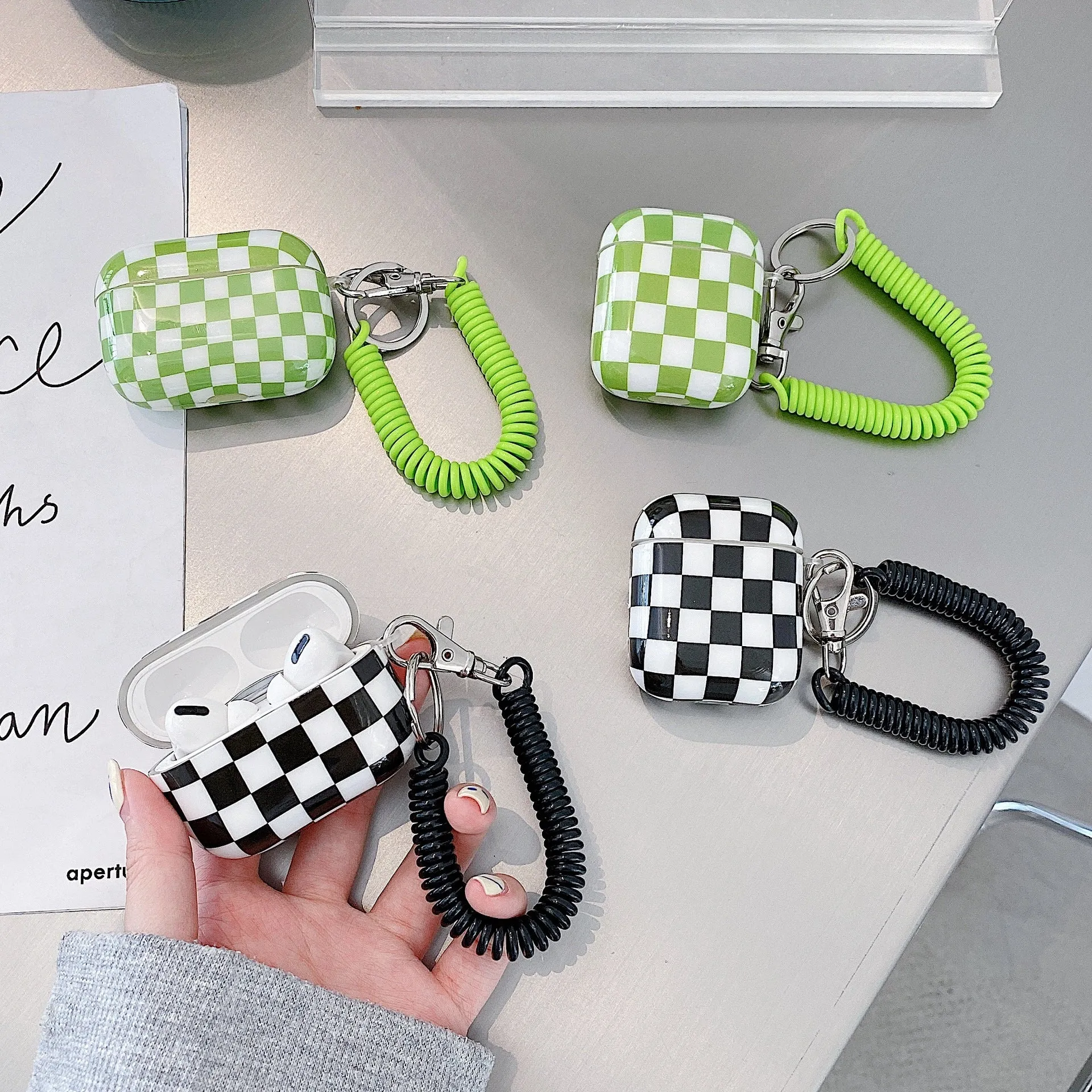 Black and green checkerboard pattern TPU case for Apple AirPods with optional pendant attachments