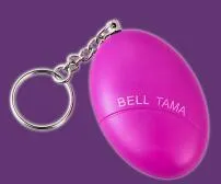 Compact keychain personal alarm in colours like black, blue, or pink showing the pull-out activation tab.