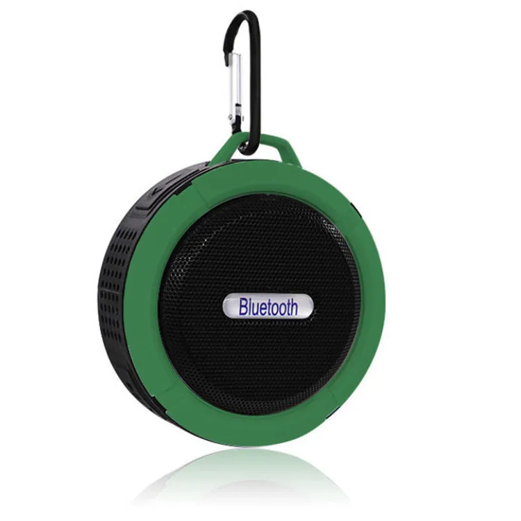 White waterproof Bluetooth speaker with a large clear suction cup mounted on a tiled wall.