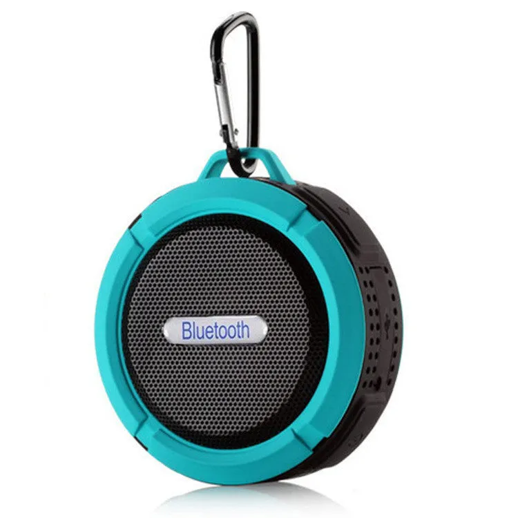 White waterproof Bluetooth speaker with a large clear suction cup mounted on a tiled wall.