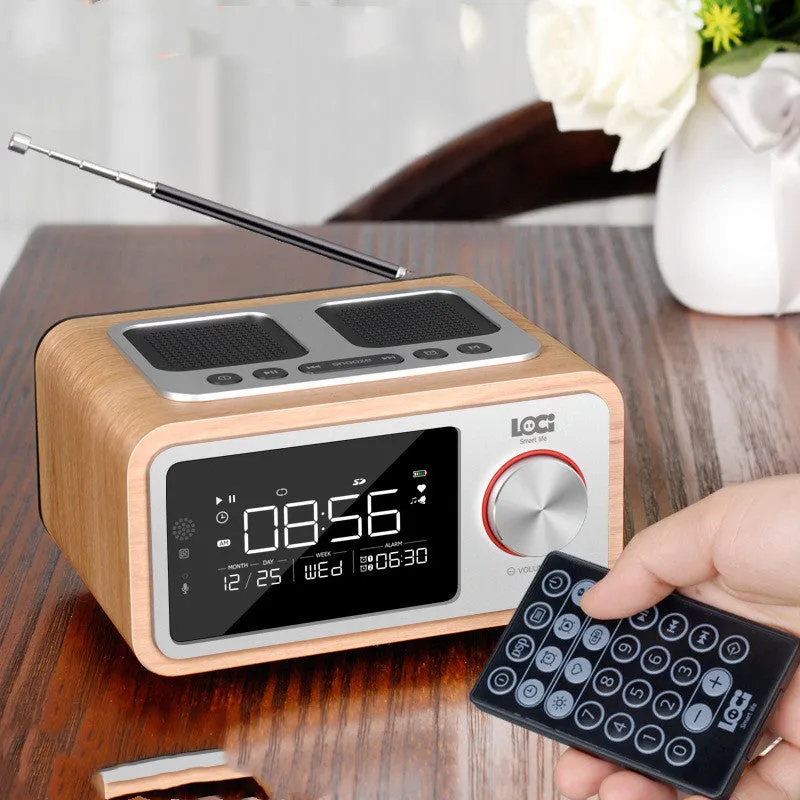 Wooden Bluetooth speaker alarm clock radio in golden oil colour on a bedside table.