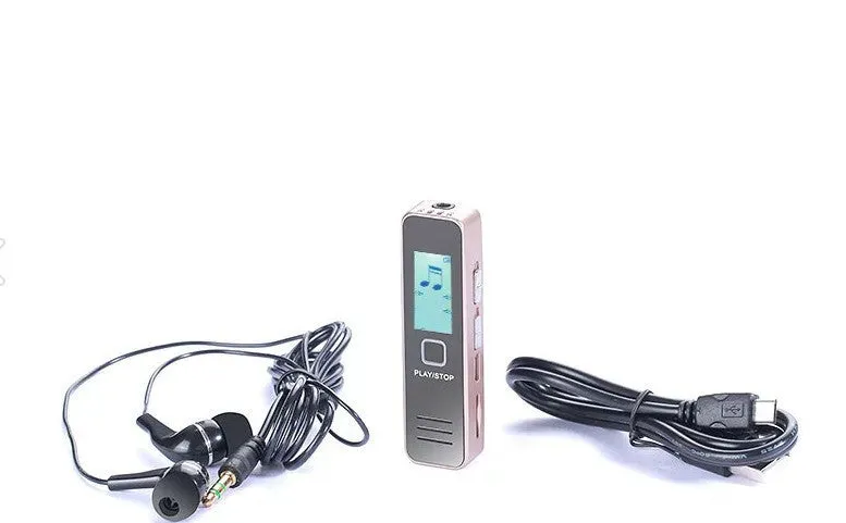 Small black or gold portable digital voice recorder with USB cable on a desk.